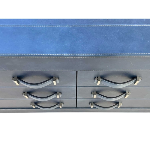 413 - ± Superyacht furnishings, a blue leather chest of six drawers. Two sets of three drawers over a wood... 