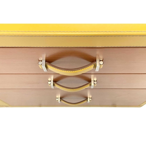 422 - ± Superyacht furnishings, a yellow leather bank of nine-drawers. Wood veneer fronts, two small drawe... 