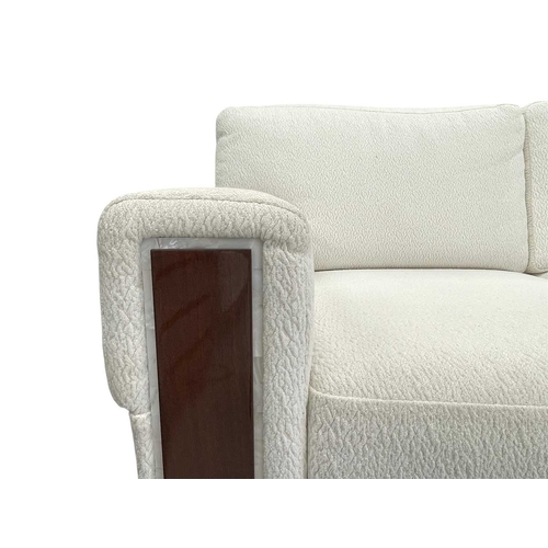 424 - ± Superyacht furnishings, a contemporary three/four seater sofa with white boucle fabric. On a highl... 