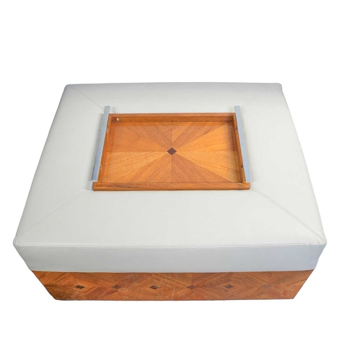 428 - ± Superyacht furnishings. Two beige leather unholstered ottomans with trays. With diamond design woo... 