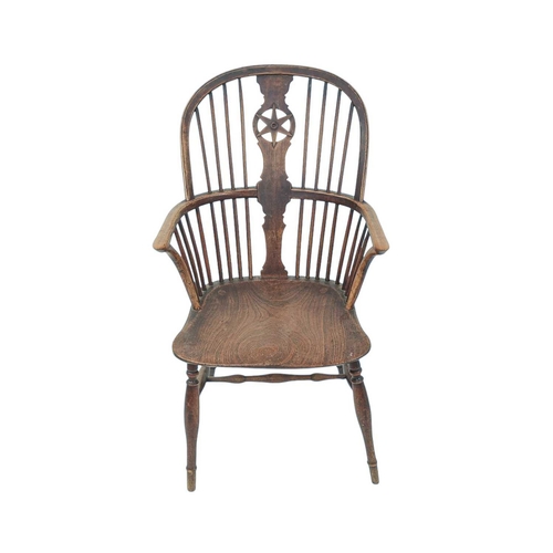 433 - An ash and elm Windsor armchair. 19th century, with pierced star back, solid seat and turned legs, h... 