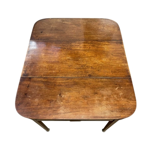 436 - A late George III mahogany concertina action dining table. With D-shaped end sections, on tapered le... 