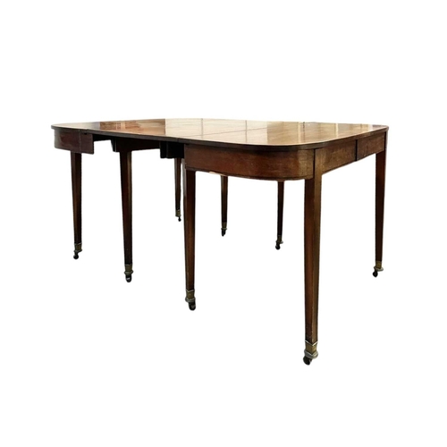 436 - A late George III mahogany concertina action dining table. With D-shaped end sections, on tapered le... 