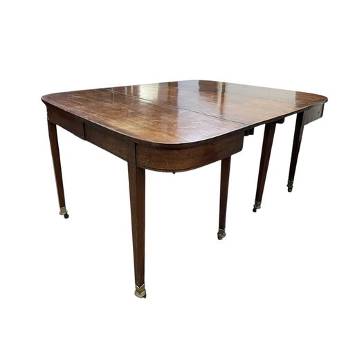 436 - A late George III mahogany concertina action dining table. With D-shaped end sections, on tapered le... 