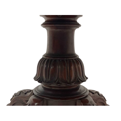 440 - An early Victorian rosewood centre table. With a shaped top on a lappet carved pillar and quadruped ... 