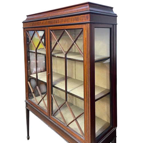 445 - An Edwardian mahogany, crossbanded, and inlaid display cabinet. With a swept festoon inlaid cornice ... 