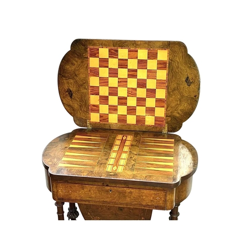 447 - A Victorian burr walnut games and sewing table. Folding swivel top, inlaid for chess, backgammon and... 