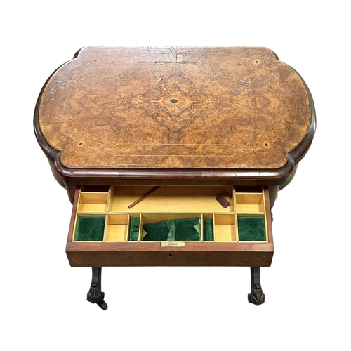 447 - A Victorian burr walnut games and sewing table. Folding swivel top, inlaid for chess, backgammon and... 