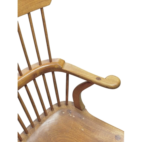 449 - A comb back ash and elm Windsor armchair by Peter Marshall. Circa 1960-70, stamped mark and monogram... 