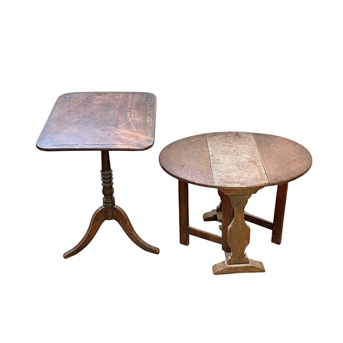 452 - A George IV mahogany tilt top table. A rectangular top, on tripod legs, with a turned central column... 