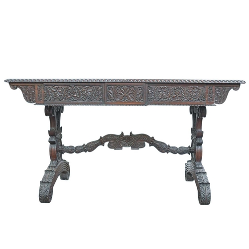 454 - A George IV Anglo Indian Padouk library table. The rectangular top with a gadrooned edge above two d... 