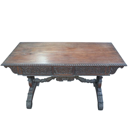 454 - A George IV Anglo Indian Padouk library table. The rectangular top with a gadrooned edge above two d... 