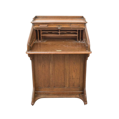 461 - An oak narrow roll top desk. Circa 1920, with a tambour top and fitted with four side drawers, Harro... 