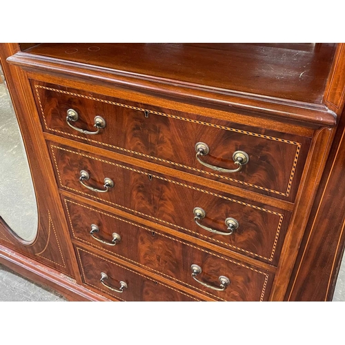 463 - An Edwardian mahogany inlaid triple wardrobe. Featuring boxwood and ebony inlay, four drawers under ... 