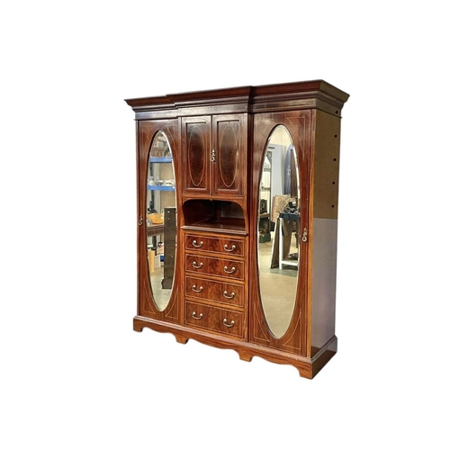 463 - An Edwardian mahogany inlaid triple wardrobe. Featuring boxwood and ebony inlay, four drawers under ... 