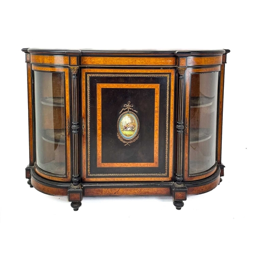 465 - A Victorian ebonised, amboyna banded, and gilt metal mounted credenza. The panel door inset an oval ... 