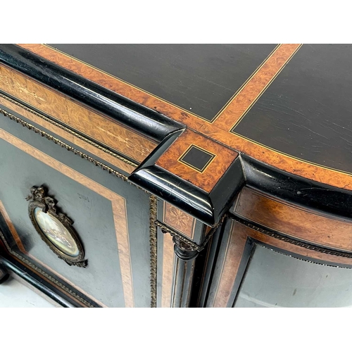 465 - A Victorian ebonised, amboyna banded, and gilt metal mounted credenza. The panel door inset an oval ... 