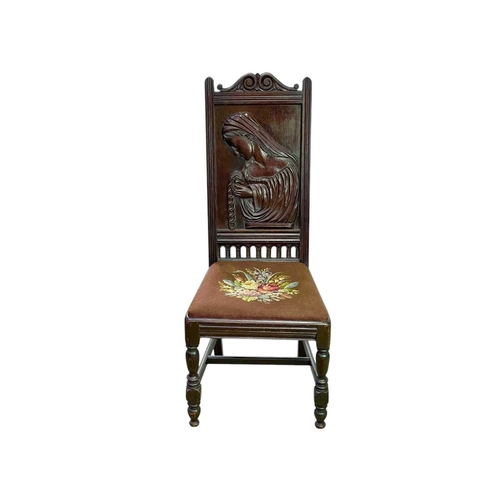 470 - A carved oak hall chair. Circa 1900, the panel carved with a veiled maiden, on turned legs, height 1... 