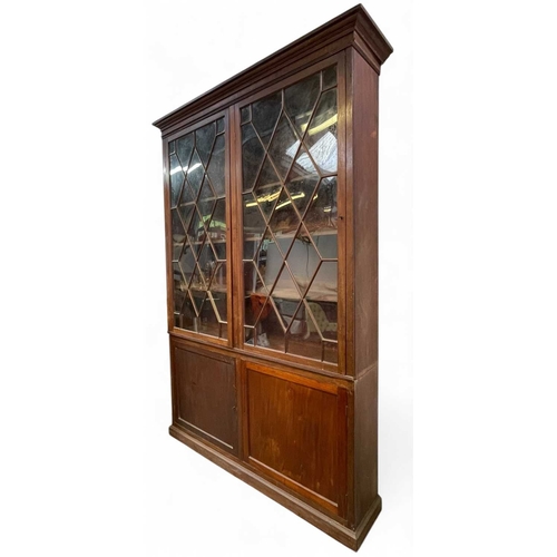 471 - A mahogany bookcase cabinet. George III, but later adapted and altered, with a removable cornice abo... 