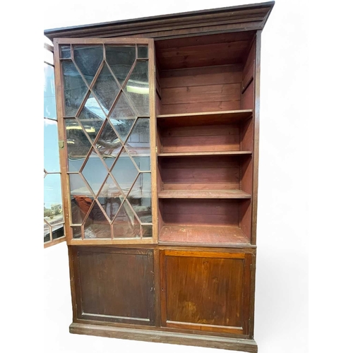 471 - A mahogany bookcase cabinet. George III, but later adapted and altered, with a removable cornice abo... 