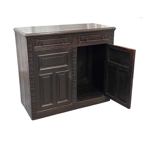 473 - A Continental carved oak buffet. 19th century, fitted with two drawers, above two panel doors within... 