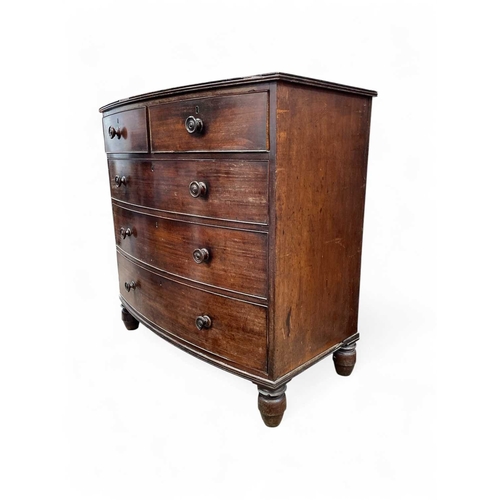 476 - An early Victorian mahogany bow front chest. Fitted two short and three long drawers, on turned feet... 