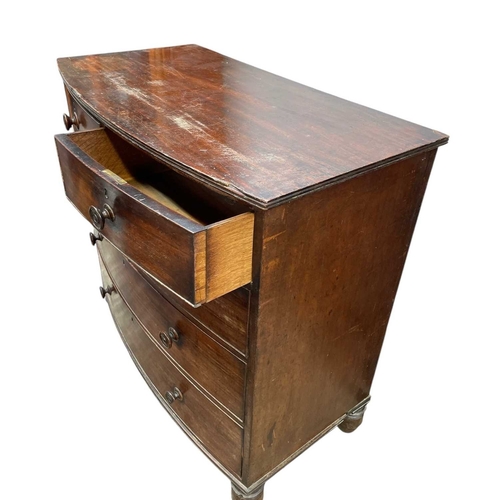 476 - An early Victorian mahogany bow front chest. Fitted two short and three long drawers, on turned feet... 