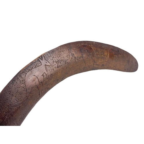 48 - An aboriginal hardwood boomerang. With incised kangaroo decoration, length 70.5cm.