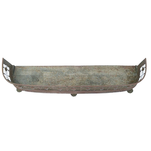 480 - A polished steel fender. Circa 1840, with pierced decoration and raised on brass lion's paw feet, wi... 