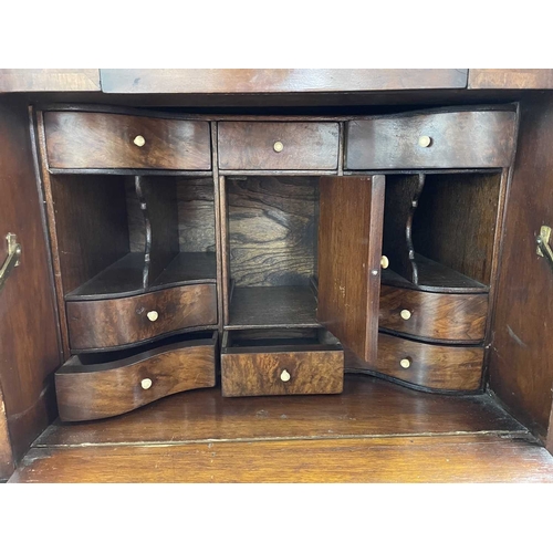 483 - A walnut veneered tallboy chest. 20th century, in the early 18th century style, with a cushion friez... 