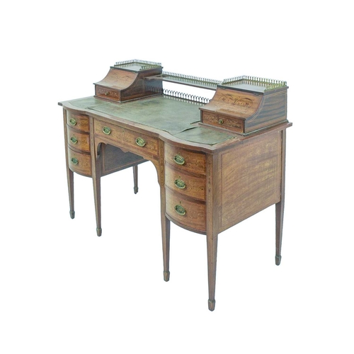 484 - A late Victorian mahogany and inlaid writing desk. The galleried superstructure with lift front comp... 