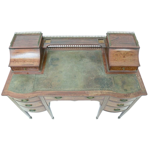 484 - A late Victorian mahogany and inlaid writing desk. The galleried superstructure with lift front comp... 