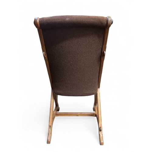 486 - An Arts and Crafts walnut armchair. With pegged X frame support, originally with caned seat, height ... 