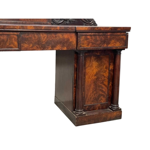 488 - A William IV figured mahogany twin pedestal sideboard. The raised back with a central tablet flanked... 