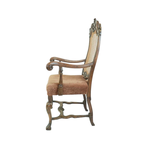 491 - A Carolean style walnut framed elbow chair. Circa 1900, with caned back, upholstered seat and wavy s... 