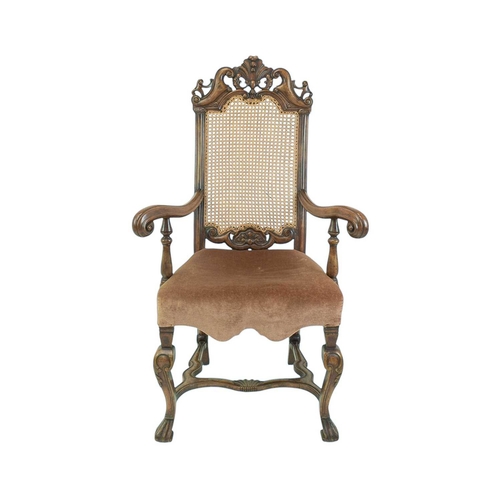 491 - A Carolean style walnut framed elbow chair. Circa 1900, with caned back, upholstered seat and wavy s... 