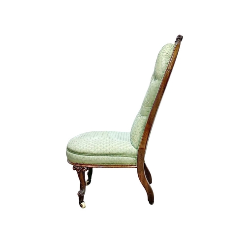 497 - A Victorian rosewood framed nursing chair. With green ribbon printed button upholstery, on carved ca... 