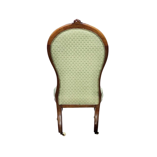 497 - A Victorian rosewood framed nursing chair. With green ribbon printed button upholstery, on carved ca... 