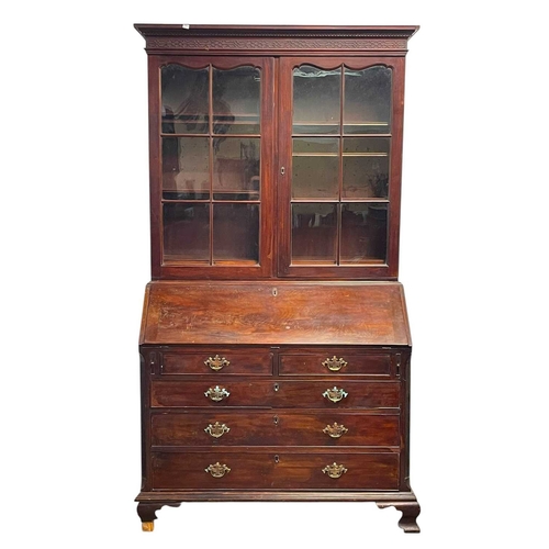 502 - A George III mahogany bureau and bookcase. The upper part with two glazed doors, the lower part with... 