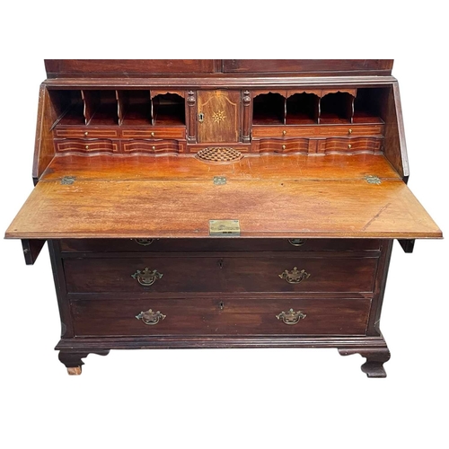 502 - A George III mahogany bureau and bookcase. The upper part with two glazed doors, the lower part with... 