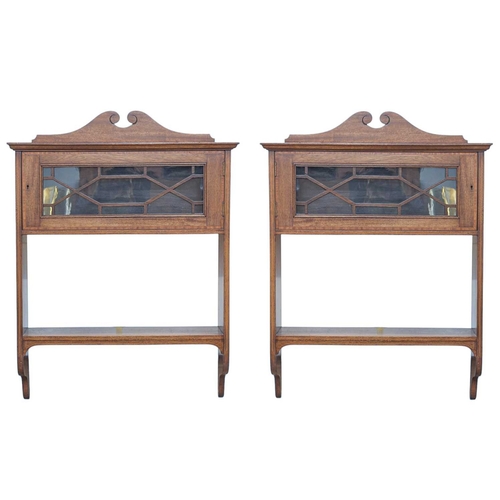 505 - A pair of Edwardian mahogany and inlaid wall cabinets. Each fitted a satinwood banded glazed door ab... 