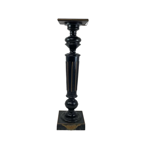 506 - A Victorian ebonised torchere. With a gilt metal mounted fluted column, on a square base, height 107... 