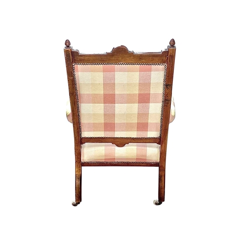 508 - A Victorian walnut framed armchair, in the Manner of E W Godwin. With blind carved and incised decor... 