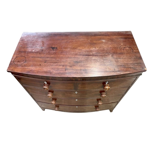 509 - A late George III mahogany bow front chest. Fitted two short and three long drawers, with turned kno... 