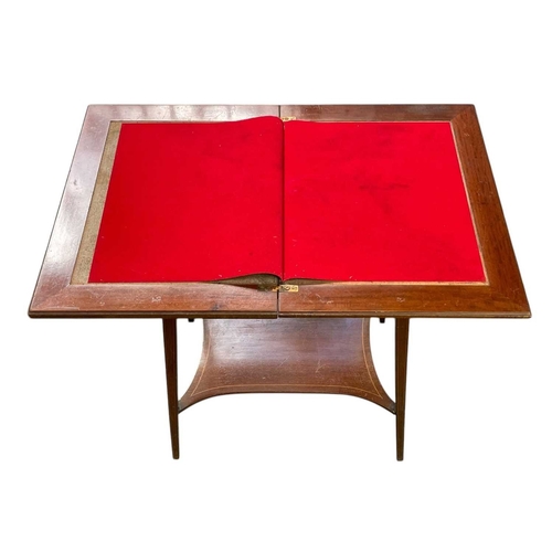 510 - An Edwardian mahogany and satinwood banded fold top card table. Inlaid with musical instruments and ... 