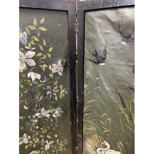 515 - A folding screen with handpainted floral decoration. Three canvas panels, black painted wood surroun... 