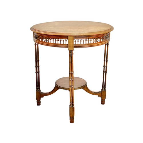 516 - An Edwardian mahogany circular occasional table. With a pierced frieze and raised on turned cluster ... 