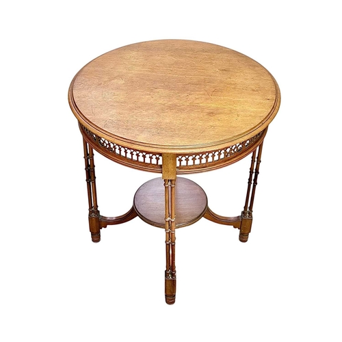 516 - An Edwardian mahogany circular occasional table. With a pierced frieze and raised on turned cluster ... 