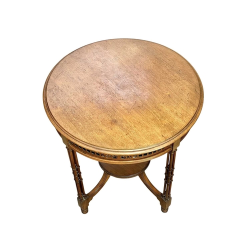 516 - An Edwardian mahogany circular occasional table. With a pierced frieze and raised on turned cluster ... 