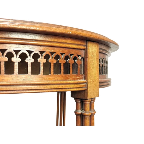 516 - An Edwardian mahogany circular occasional table. With a pierced frieze and raised on turned cluster ... 